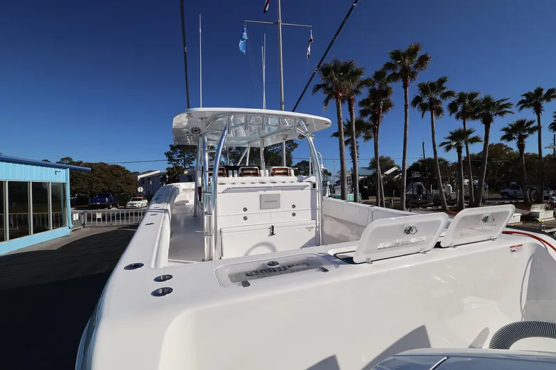 Slide: The Image of 2026 Contender 44 CB boat docked at marina, showcasing sleek design and spacious deck. - 31