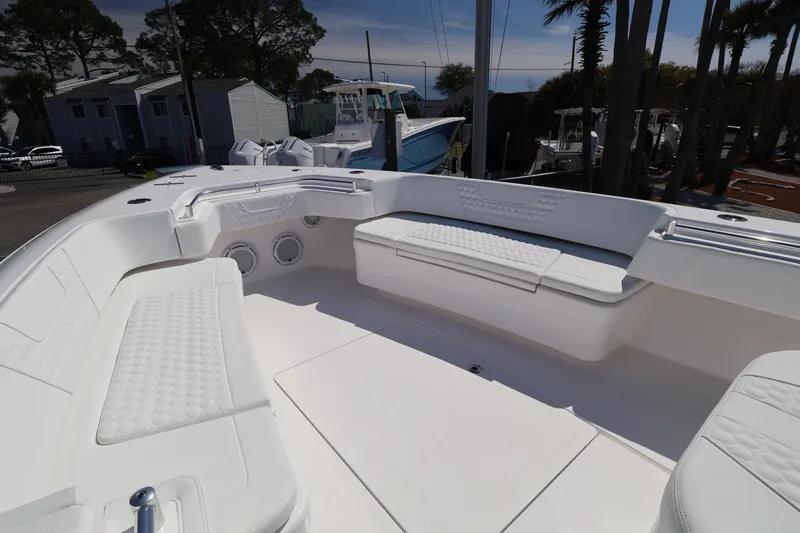 Slide: The Image of 2026 Contender 44 CB boat interior with white cushioned seating and sleek design. - 35