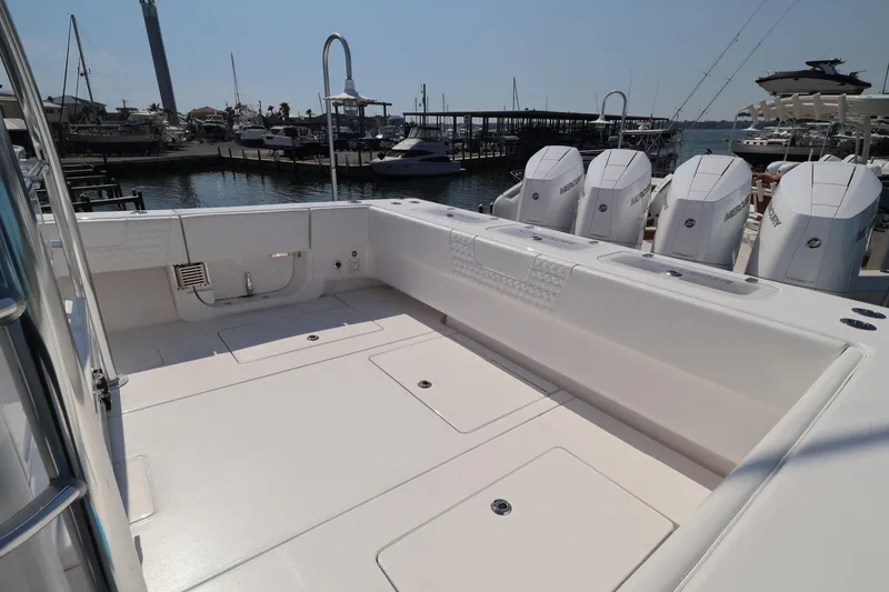 Slide: The Image of Contender 44 CB 2026 boat with spacious deck and powerful outboard engines at marina. - 42