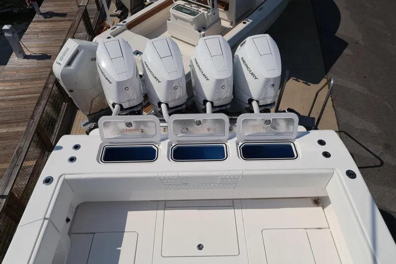 Slide: The Image of Four powerful Mercury outboard engines on a 2026 Contender 44 CB boat. - 45