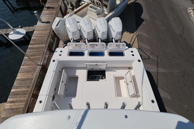 Slide: The Image of 2026 Contender 44 CB boat with quad Mercury engines docked at marina. - 46