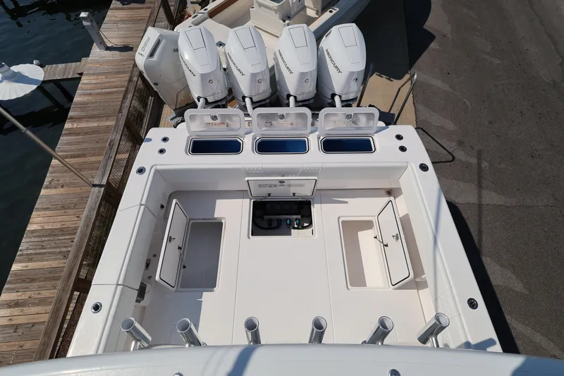 Slide: The Image of 2026 Contender 44 CB boat with four powerful outboard engines at dock. - 47