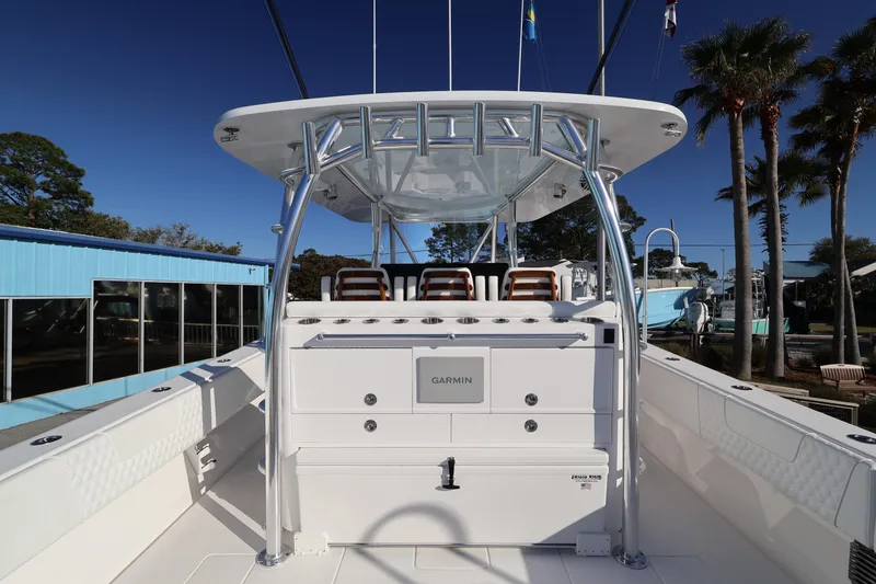 Slide: The Image of 2026 Contender 44 CB boat with Garmin equipment, docked under clear blue sky. - 52