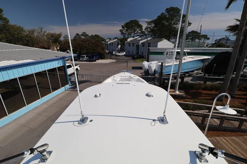 Slide: The Image of Top view of a 2026 Contender 44 CB boat docked near a marina. - 55
