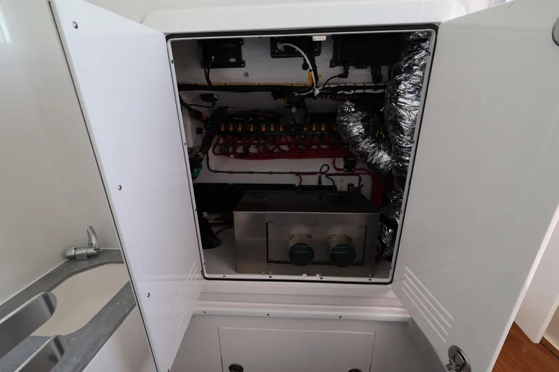 Slide: The Image of Electrical panel of 2026 Contender 44 CB boat with open access door. - 62