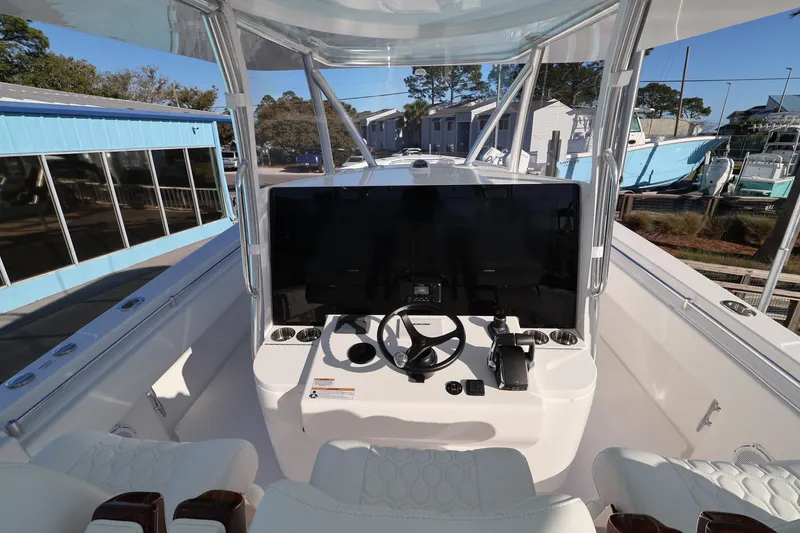 Slide: The Image of 2026 Contender 44 CB boat helm with modern controls and seating. - 7