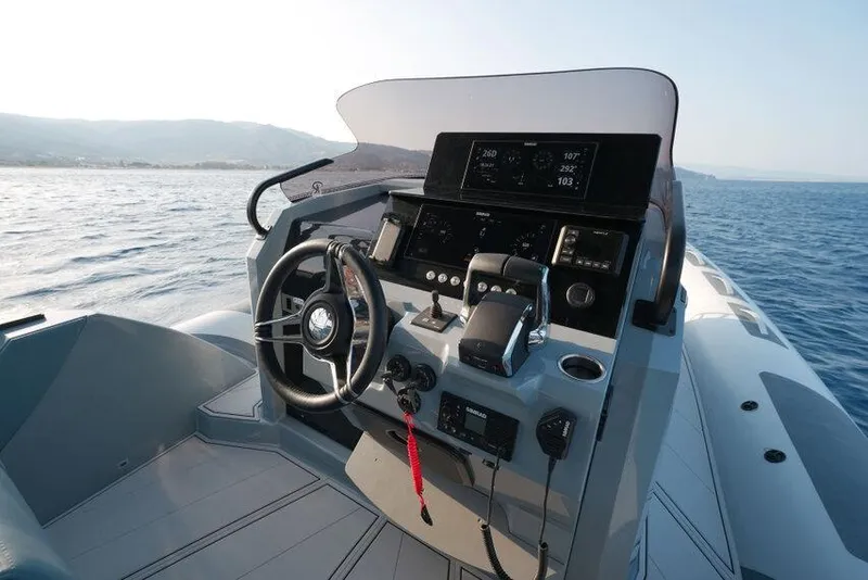 Slide: The Image of Cockpit view of 2026 Ranieri CAYMAN 33.0 EXECUTIVE boat on open water. - 27