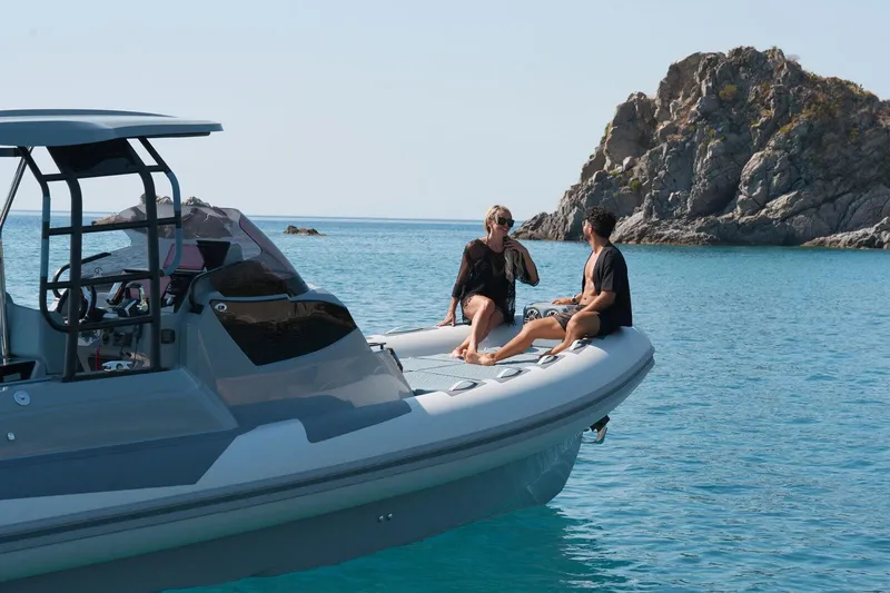 Slide: The Image of Couple relaxing on a 2026 Ranieri CAYMAN 33.0 EXECUTIVE boat in serene waters. - 36