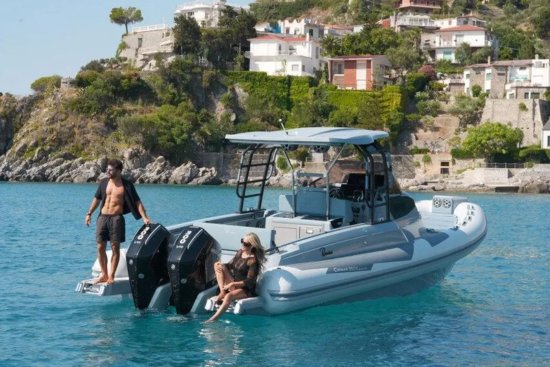 Slide: The Image of 2026 Ranieri CAYMAN 33.0 EXECUTIVE boat on turquoise water near coastal villas. - 37