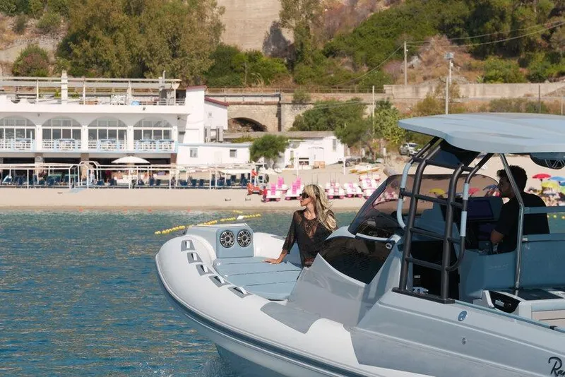 Slide: The Image of 2026 Ranieri CAYMAN 33.0 EXECUTIVE yacht near a scenic beach with a passenger onboard. - 39