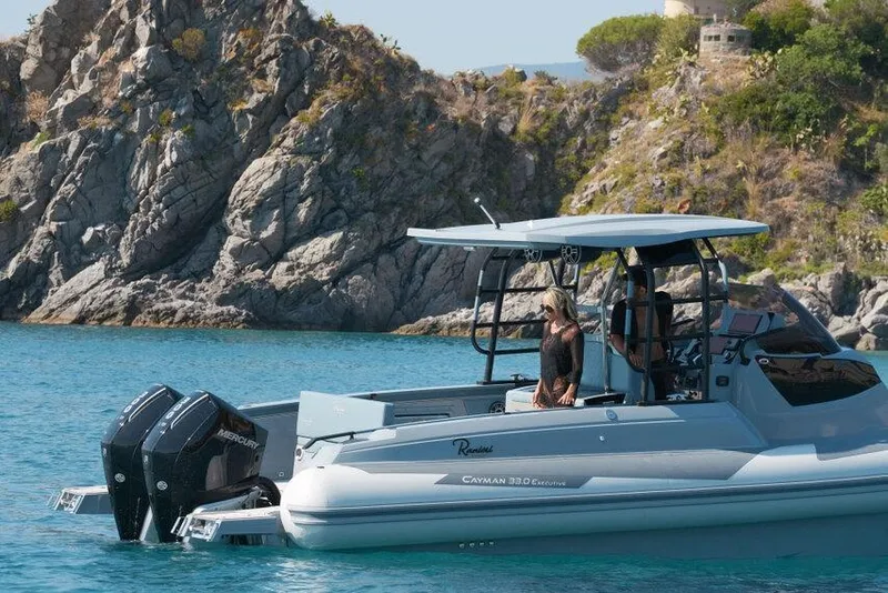 Slide: The Image of 2026 Ranieri CAYMAN 33.0 EXECUTIVE boat cruising near rocky coastline. - 40