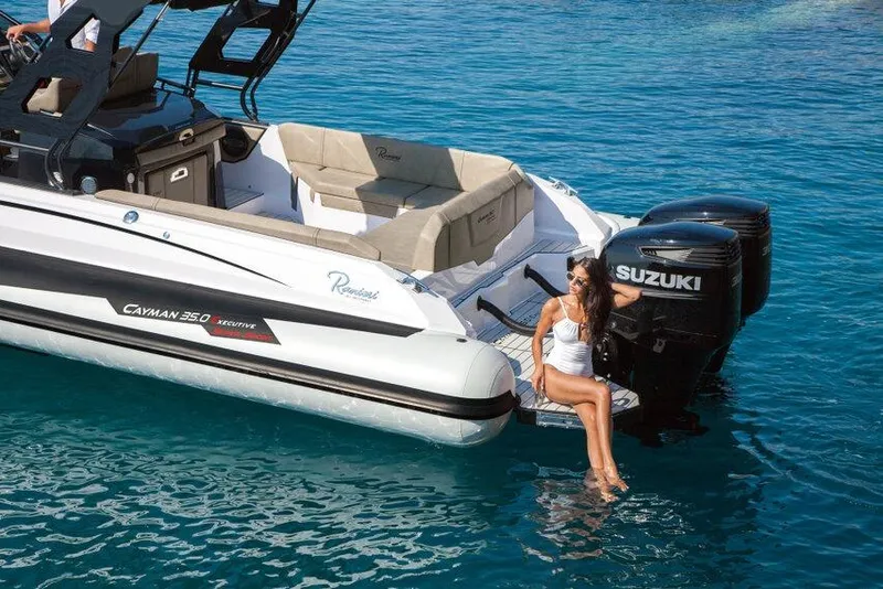 Slide: The Image of 2026 Ranieri CAYMAN 35.0 EXECUTIVE boat with Suzuki engines on clear blue water. - 12