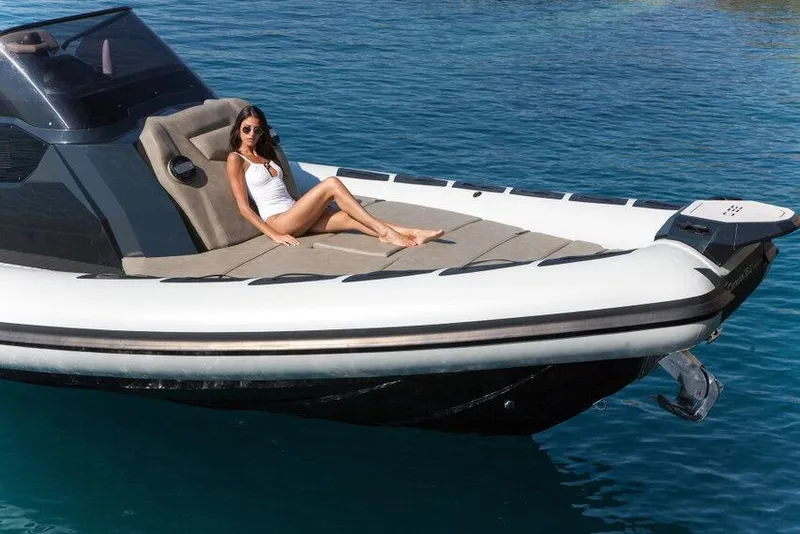 Slide: The Image of Woman relaxing on 2026 Ranieri CAYMAN 35.0 EXECUTIVE boat in clear blue water. - 13
