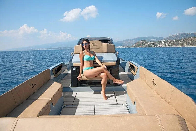 Slide: The Image of Woman relaxing on a 2026 Ranieri CAYMAN 38.0 EXECUTIVE yacht in sunny ocean setting. - 8