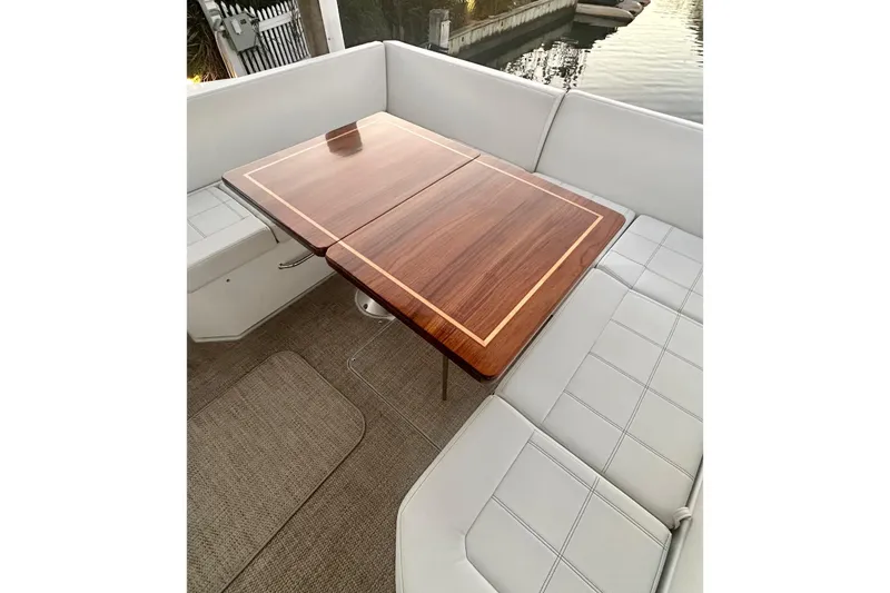 Slide: The Image of Luxurious seating area with wooden table on 2015 Cruisers Yachts 390 Express Coupe. - 10