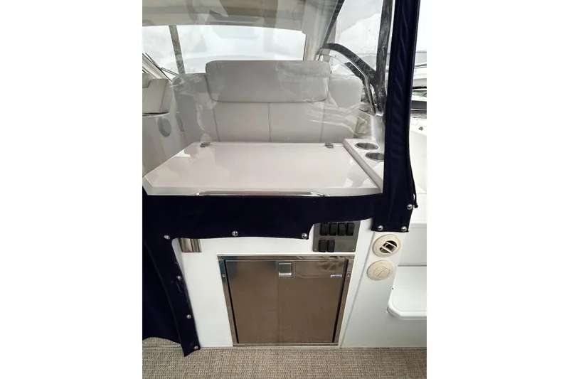 Slide: The Image of 2015 Cruisers Yachts 390 Express Coupe interior with seating and storage area. - 11
