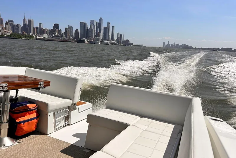 Slide: The Image of 2015 Cruisers Yachts 390 Express Coupe cruising with city skyline in background. - 13