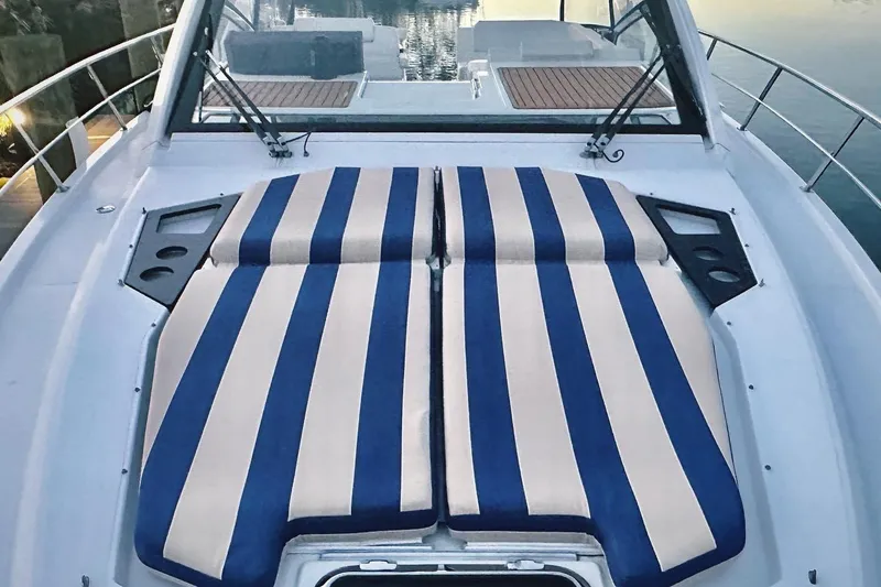 Slide: The Image of 2015 Cruisers Yachts 390 Express Coupe with striped sunbathing cushions on deck. - 14