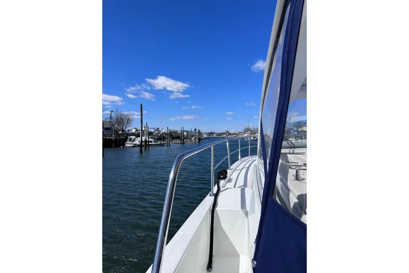 Slide: The Image of 2015 Cruisers Yachts 390 Express Coupe on a sunny day at the marina. - 15