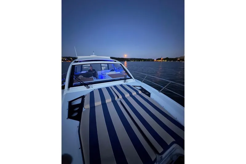 Slide: The Image of 2015 Cruisers Yachts 390 Express Coupe on serene water at dusk. - 16