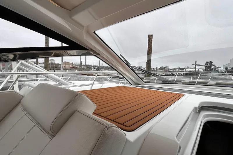 Slide: The Image of Interior view of 2015 Cruisers Yachts 390 Express Coupe with sleek design and waterfront backdrop. - 18