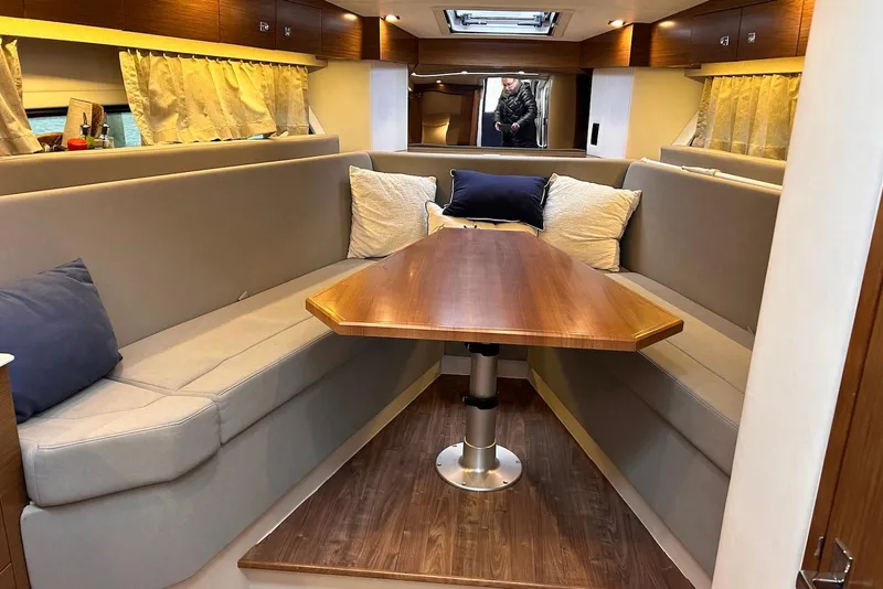 Slide: The Image of Interior of 2015 Cruisers Yachts 390 Express Coupe with elegant seating and wooden table. - 20