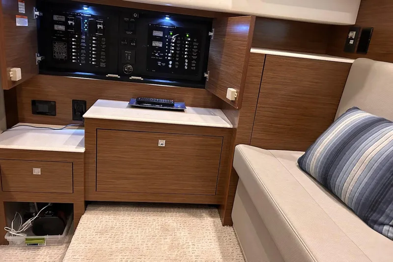 Slide: The Image of Interior of 2015 Cruisers Yachts 390 Express Coupe with control panel and seating area. - 23