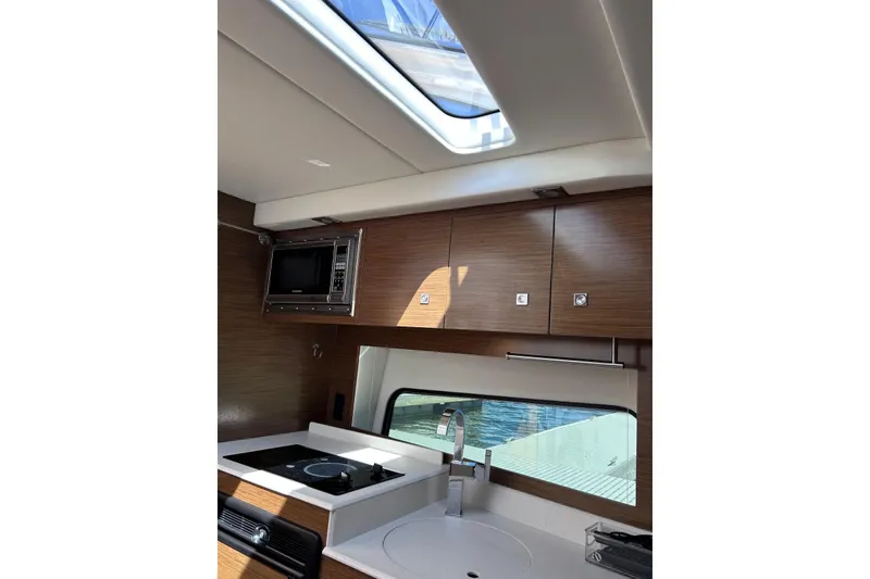 Slide: The Image of Interior of 2015 Cruisers Yachts 390 Express Coupe with modern kitchen amenities. - 26