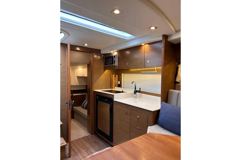 Slide: The Image of Luxurious interior of 2015 Cruisers Yachts 390 Express Coupe with modern kitchen amenities. - 29