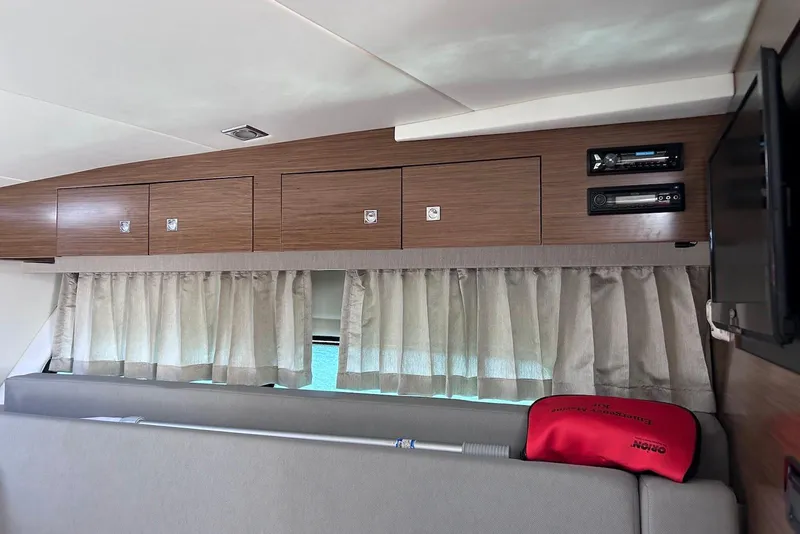 Slide: The Image of Interior of 2015 Cruisers Yachts 390 Express Coupe with wood cabinets and curtains. - 30