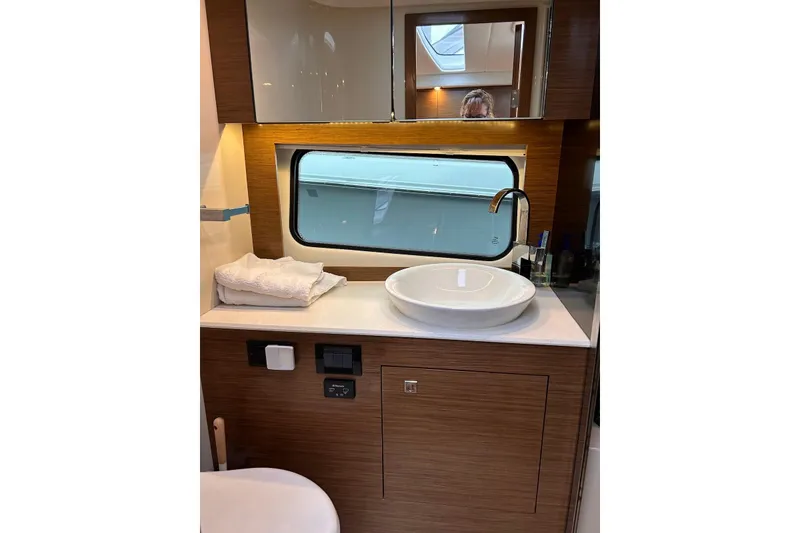 Slide: The Image of Luxurious bathroom interior of 2015 Cruisers Yachts 390 Express Coupe with modern sink and mirror. - 31