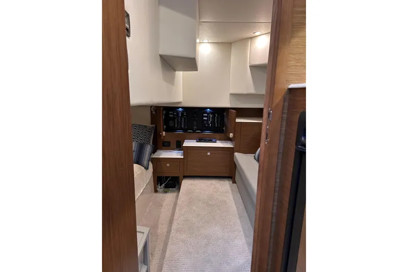 Slide: The Image of Interior of 2015 Cruisers Yachts 390 Express Coupe, featuring modern wood cabinetry and seating. - 33