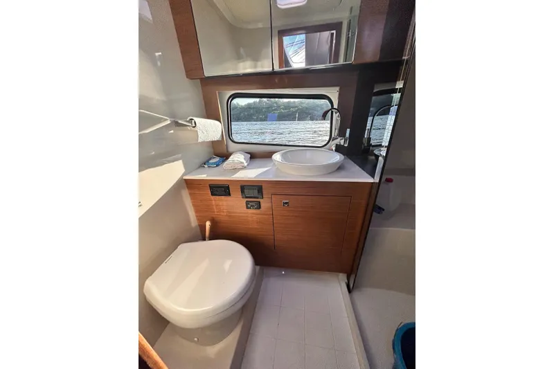 Slide: The Image of Luxurious bathroom interior of 2015 Cruisers Yachts 390 Express Coupe with scenic window view. - 38