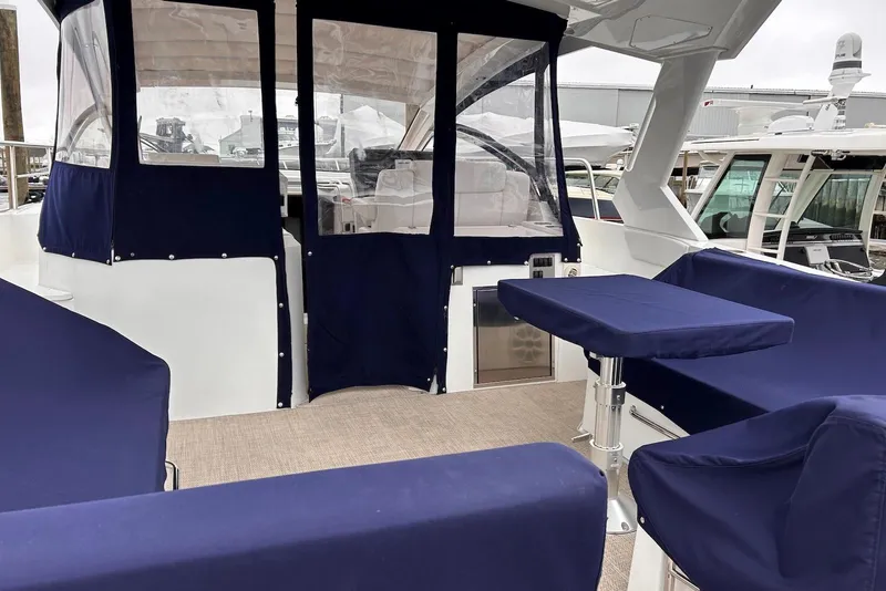 Slide: The Image of 2015 Cruisers Yachts 390 Express Coupe interior with blue seating and covered cockpit. - 7