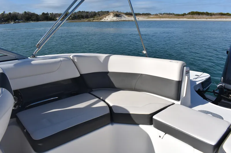 Slide: The Image of 2017 Chaparral 230 Suncoast boat interior with comfortable seating on calm water. - 10