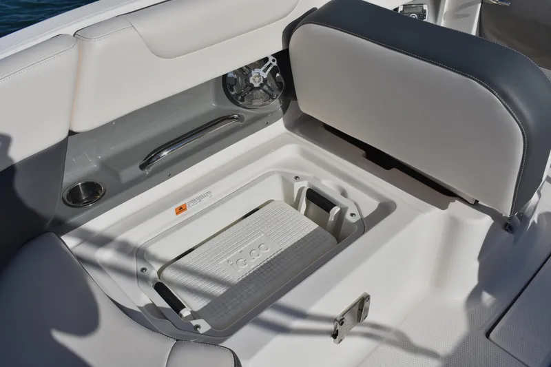 Slide: The Image of 2017 Chaparral 230 Suncoast boat interior with storage compartment and seating. - 11