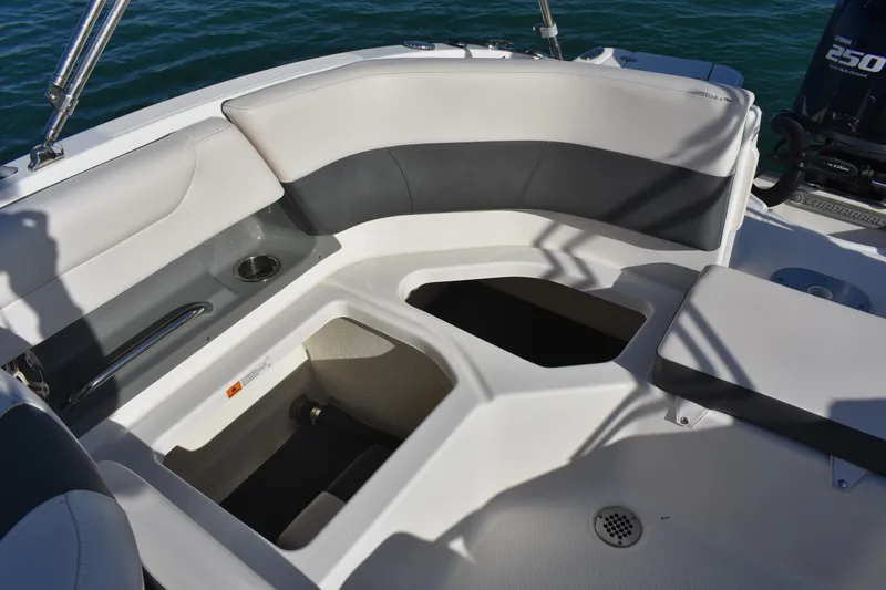 Slide: The Image of 2017 Chaparral 230 Suncoast boat interior with seating and storage compartments. - 13