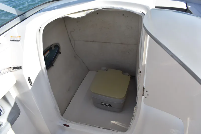 Slide: The Image of Interior of 2017 Chaparral 230 Suncoast boat with compact marine toilet. - 16