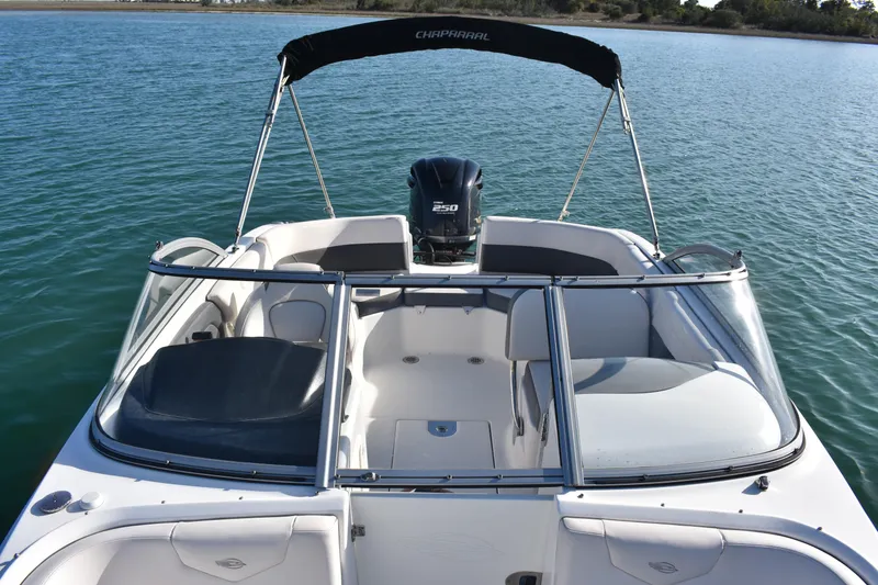 Slide: The Image of 2017 Chaparral 230 Suncoast boat with bimini top on calm water. - 19
