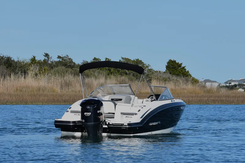 Slide: The Image of 2017 Chaparral 230 Suncoast boat on calm water with scenic background. - 2