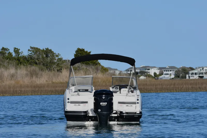 Slide: The Image of 2017 Chaparral 230 Suncoast boat on calm water with scenic background. - 3