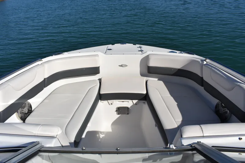 Slide: The Image of 2017 Chaparral 230 Suncoast boat interior with spacious seating on calm water. - 5