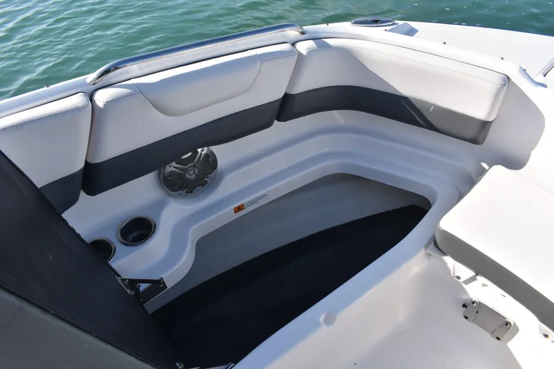 Slide: The Image of 2017 Chaparral 230 Suncoast boat interior with cushioned seating and cup holders. - 7