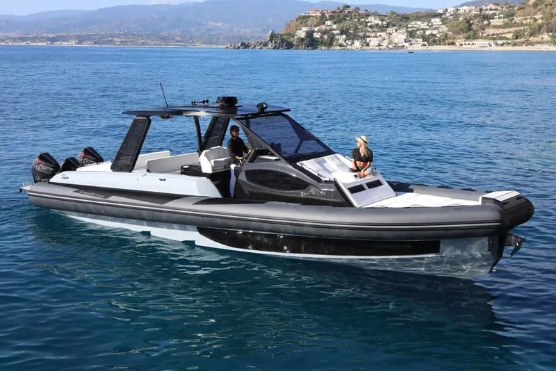 The Image of 2026 Ranieri Cayman 45.0 Executive luxury boat cruising on clear blue waters. - 0