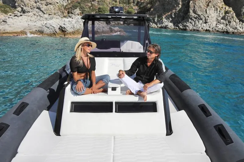Slide: The Image of Couple relaxing on 2026 Ranieri Cayman 45.0 Executive yacht in scenic coastal waters. - 16