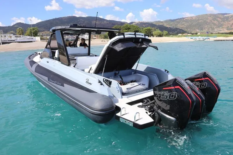 Slide: The Image of 2026 Ranieri Cayman 45.0 Executive boat on turquoise water near a scenic coastline. - 6