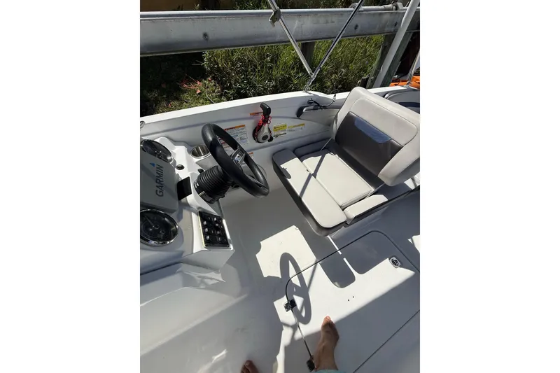 Slide: The Image of 2023 Hurricane SunDeck Sport 205 OB boat interior with steering wheel and seating. - 14