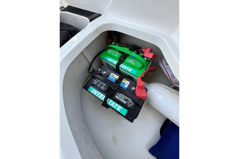 Slide: The Image of 2023 Hurricane SunDeck Sport 205 OB boat battery compartment with Interstate batteries. - 17