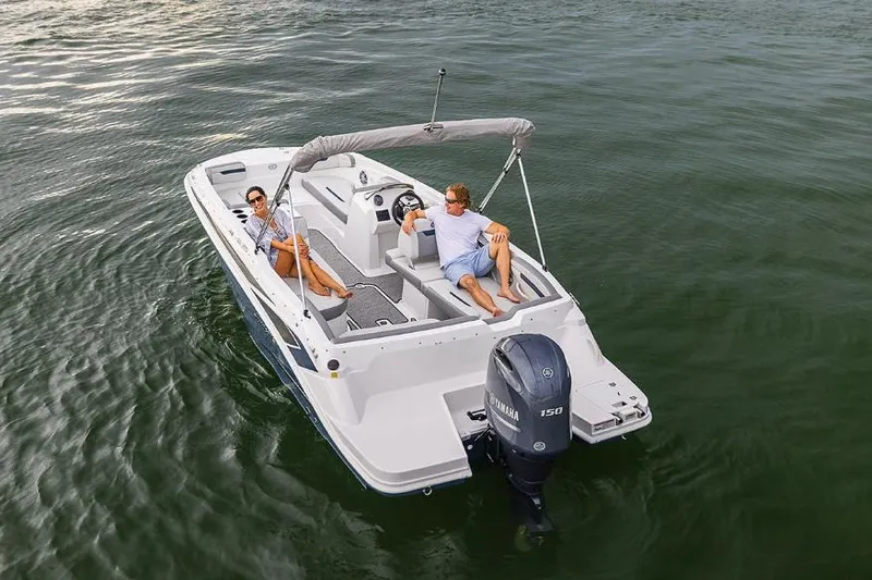 Slide: The Image of Manufacturer Provided Image: 2023 Hurricane SunDeck Sport 205 OB boat on water with two people relaxing. - 2