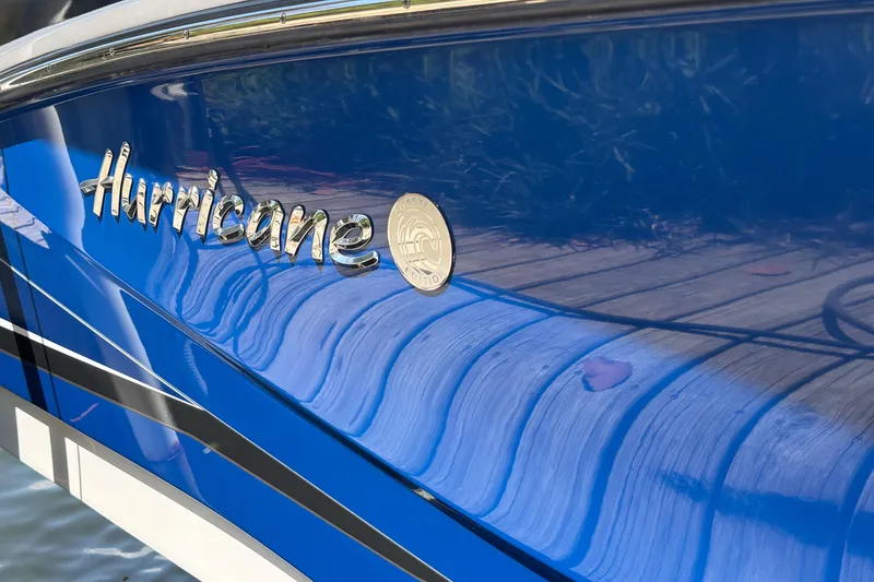 Slide: The Image of 2023 Hurricane SunDeck Sport 205 OB boat with blue exterior and logo detail. - 22